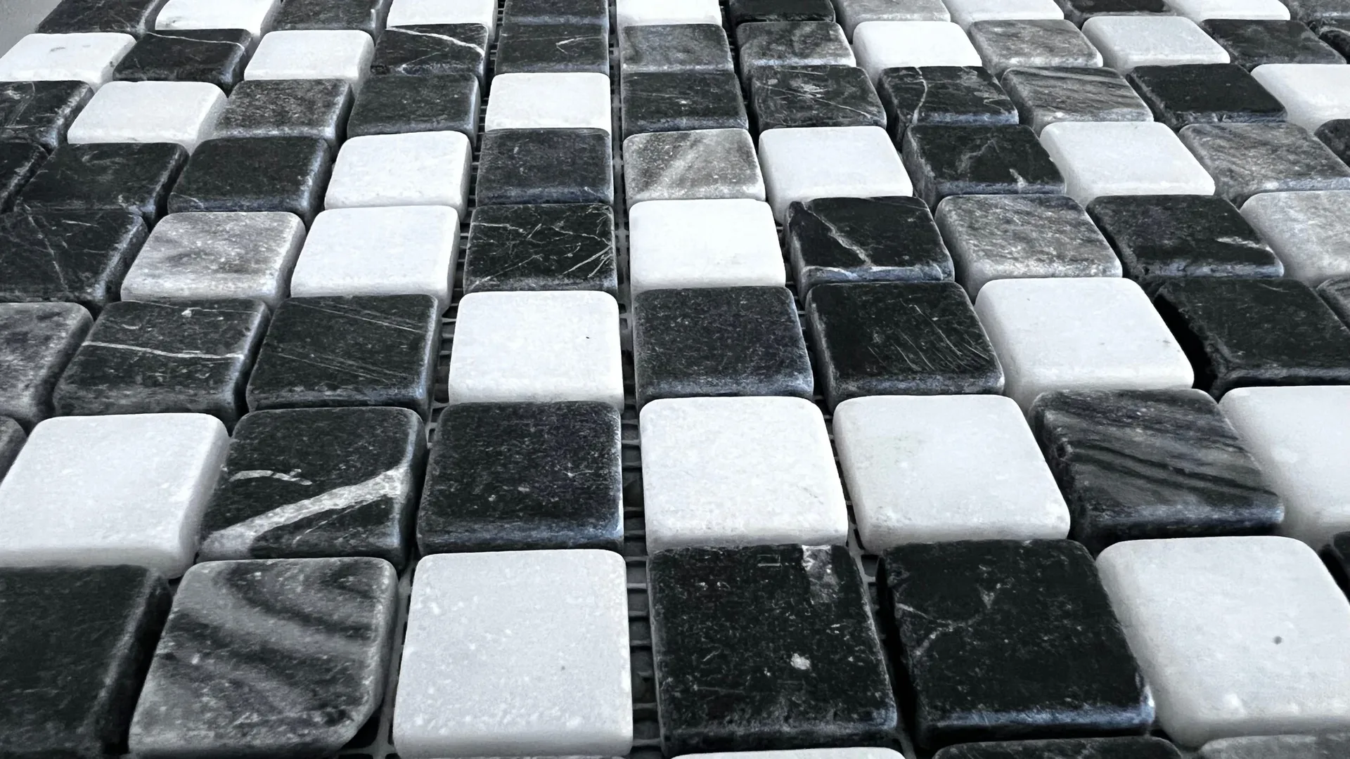 Schwarz-weißes Mosaik im Schachbrettmuster Schwarz-weißes Mosaik im Schachbrettmuster